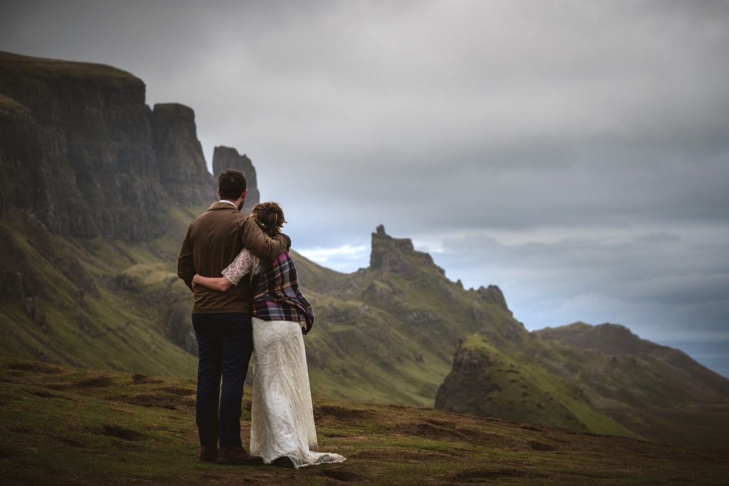 A newly-married couple stand overlooking the Old Man of Storr on Skye